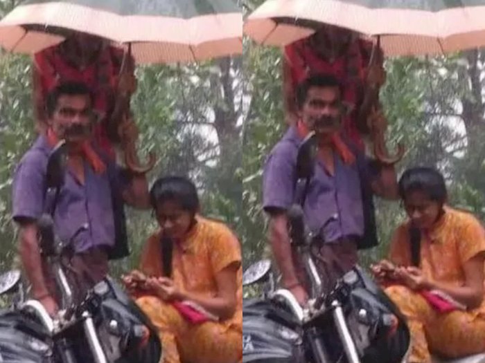 Seorang Ayah Pegang Payung saat Putrinya Hadiri Kelas Online di Tengah Hujan