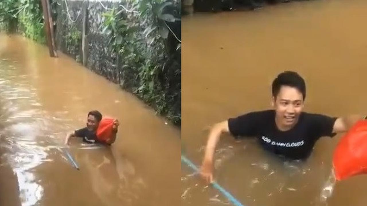 LUAR BIASA! Pria Ini Terjang Banjir Demi Antar Makanan ke Teman-temannya
